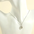 Macro detail of a 18K gold plated conch pendant on an O-chain necklace for women - White Gold