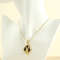 Close-up of golden bunny pendant with white cubic zirconia and snake chain on a mannequin - Two-Tone Style