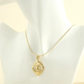 Detail of 18K gold rabbit pendant with zircons and sleek snake chain on white bust - Hollow-Out Solid Color Style (NE1979-Solid Color)