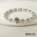 Stretch beaded bracelet with white pearls and a colorful enamel skull charm pendant - Colorful Floral Silver Skull Style (BR2013-B)