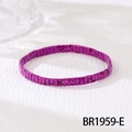 Macro shot of purple Tila bead elastic bracelet with ink splatter texture on white fabric - Purple Speckled (BR1959-E)