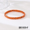 Detail shot of orange beaded bracelet with black leopard patterns in a bohemian style - Orange Speckled (BR1959-F)