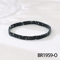 Macro shot of black bohemian beaded bracelet with white splattered patterns and elastic band - Black Speckled (BR1959-O)