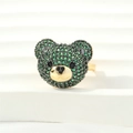 Close-up of a 3D gold bear ring featuring green micro-pave zircons and black bead eyes - Adjustable Open / Gold - Green Zirconia