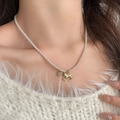 Elegant pearl necklace with golden rocking horse and rhinestone coin charms on model - Gold Horse Pearl Style