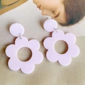 Detail of pink acrylic flower earrings featuring a two-piece drop design on fabric - Pink