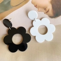 Detailed view of large acrylic flower earrings in black and white minimalist design - Black and White
