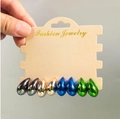 Detail view of four pairs of teardrop earrings in black, gold, blue, and green on display card - Multicolor Four Pair Combination 8