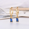 Detail view of gold hoop earrings featuring rectangular blue zircon pendants on display - Gold Plated Blue Zirconia