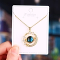 Detailed close-up of blue planet pendant with golden Saturn ring and crystal stars - Large Planet Gold - Cable Chain