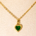 Minimalist gold necklace with a heart-shaped green zircon pendant on a beige background - Gold Green Zirconia