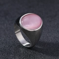 Macro detail of oval pink cat's eye stone set in a brushed silver stainless steel ring - US 6 / Silver Pink Cat's Eye