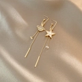Asymmetric gold tassel earrings featuring sparkling star and planet motifs on silk background - Gold Saturn Star Asymmetric Tassel (A302)