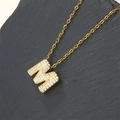 Luxury gold plated cubic zirconia letter M pendant necklace on dark stone display - Letter M (Pendant Only)