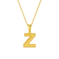 Golden necklace with textured letter Z pendant and beaded edge detail on white background - Letter Z Style / Gold