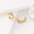 Gold plated square earrings with geometric zircon stones shown on white stone display - Gold / White
