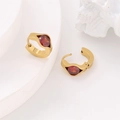 Detail view of gold earrings with oval red gemstone and vacuum plated steel texture - Red