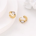 Macro detail of 304 stainless steel gold huggie earrings featuring a large round zircon stone - White