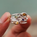 Macro shot of vintage silver rings with colorful oval and round gemstones in a set - US 6 / Silver