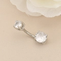 Macro shot of double-headed crystal navel ring with silver curved barbell and claw settings - 7mm / Silver