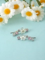 Detail of silver flower stud earrings with pink zirconia and shell-like petals - Silver