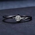 Modern black bypass ring featuring a brilliant round white gemstone with accent diamonds - US 6 / Black