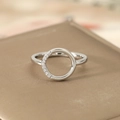 Macro detail of silver geometric ring featuring a hollow circle set with sparkling crystals - US 6 / Silver