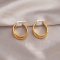 Polished gold multi-layered thick hoop earrings displayed on premium champagne silk fabric - Twisted Round Hoop Earrings / Gold