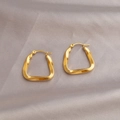 Modern twisted geometric gold hoop earrings with a polished mirror finish on silk - Geometric Twisted Style / Gold
