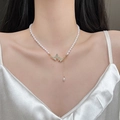 Elegante parelketting met een gouden vlinderhanger en glinsterende strass kwastjes - Dubbele Vlinder Parel Kwastje Stijl