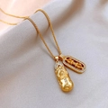 Golden PiXiu and Vajra pendant necklace with white zircons on a textured fabric background - Rhinestone Vajra Pixiu Necklace
