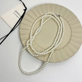Lange witte parelketting met metalen sluiting en natuurlijke warme glans voor dames - Witte parelketting