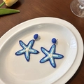 Handwoven colorful starfish earrings in blue and white for summer beach vacation style - Blue