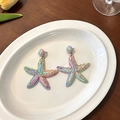 Colorful raffia starfish drop earrings in vibrant macaron shades for a summer resort look - Colorful