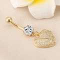 Macro detail of a gold heart belly ring featuring sparkling cubic zirconia on fabric - Full Zirconia Heart Gold