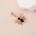 Rose gold spider belly button ring with black zircon crystals on a clean stone background - Rose Gold