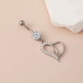 Elegant heart-shaped belly button ring with sparkling zirconia on warm beige background - Classic Heart Navel Ring Silver
