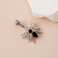 Silver spider belly button ring with black zircon stones on soft pink background - Silver