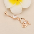 Macro detail of rose gold heart belly ring with white zircon stones and curved bar - Hollow Heart Zirconia Rose Gold