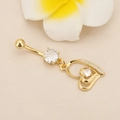 Macro detail of gold-plated navel ring with hollow heart pendant and zircon stones - Hollow Heart Zirconia Gold
