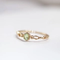 Macro view of gold镂空 adjustable ring with green oval gemstone and zircon detailing - US 7 / Gold