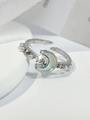 Detailed close-up of a silver crescent moon ring with blue stone and tiny white pearls - Silver