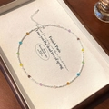 Kleurrijke ketting met gefacetteerde kristallen kralen en zilveren accenten - Kleurrijke kristal verpletterde zilveren ketting