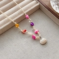 Bohemian woven cord necklace with colorful beads and white shell pendant on beige box - Multicolor Stone Shell Necklace