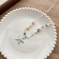 Starfish necklace with turquoise beads and pearls on a white ceramic tray - White Starfish Pendant Necklace