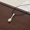 Silver spoon pendant necklace with adjustable black cord on a rustic wooden tray - Leather Cord Silver Spoon Necklace