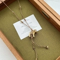 Abstract golden elephant pendant on brown braided rope necklace with golden beads - Gold