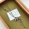 Silver dog pendant necklace with black leather cord and tassel fringe detail - Silver