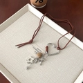 Long leather necklace with heart clasp, flower pendant and dog tag in brown tones - Brown