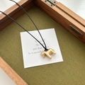 Elegant golden pony pendant on black cord necklace, displayed in a wooden gift box - Brushed Gold Horse Necklace